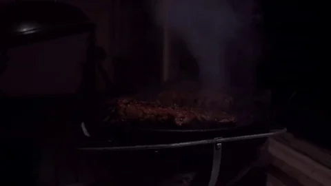 Flipping a steak at a barbecue 스톡 동영상 74111292