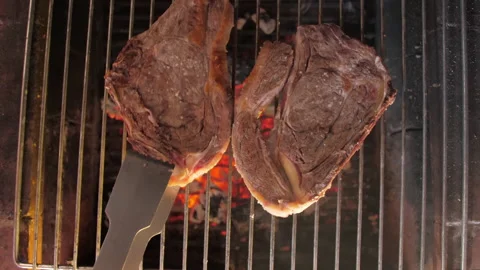 Flipping steak beef on grill slow motion 4k Stock Footage 146485892