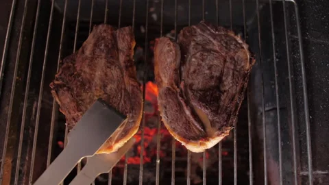 Flipping steak beef on grill slow motion Stock Footage 146491733