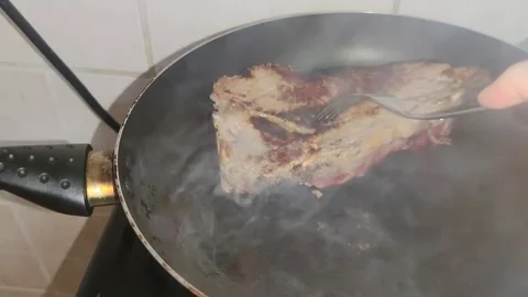 Flipping the steak in the pan 動画素材 241691769