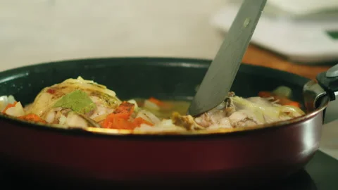 Flipping stewing chicken thighs Video stock 165598309