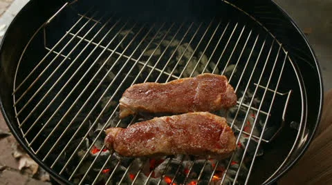 Flipping Strip Steaks Stock Footage 22576654