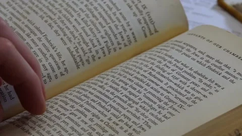 Flipping through a book 스톡 동영상 155963084