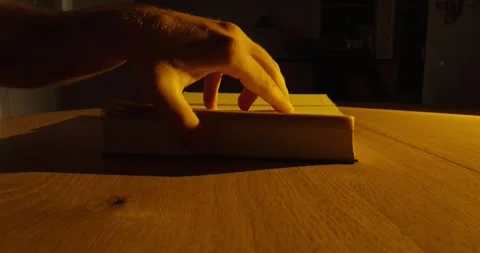 Flipping Through Book Pages in Cinematic Lighting Stock Footage 346262552