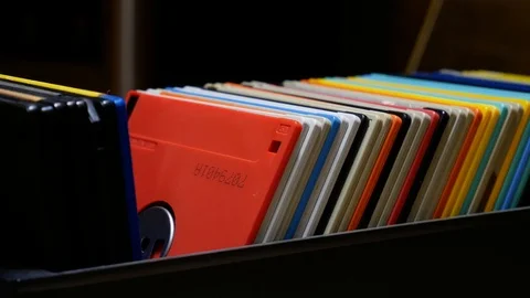 Flipping through floppy disks in floppy disks storage box. Stock Footage 107692472