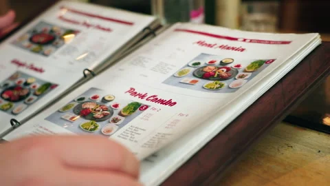 Flipping through a menu at a Korean restaurant 스톡 동영상 248238170
