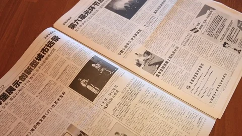 Flipping through a newspaper in Chinese Video stock 98836610