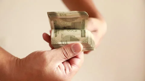 Flipping through a stack of Indian Five Hundred Indian Rupee bills or notes Stock Footage 166504686