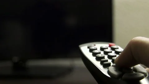 Flipping through tv stations with hotel remote 4k Stock Footage
