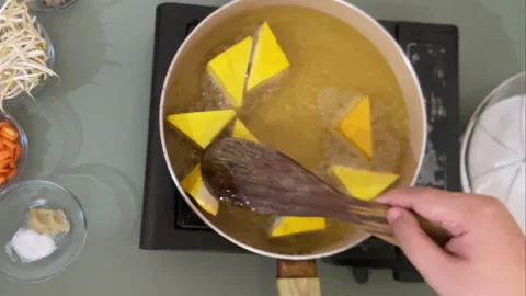 Flipping Tofu While Cooking in Hot Oil Close Up Kitchen Footage Stock Footage 310277950