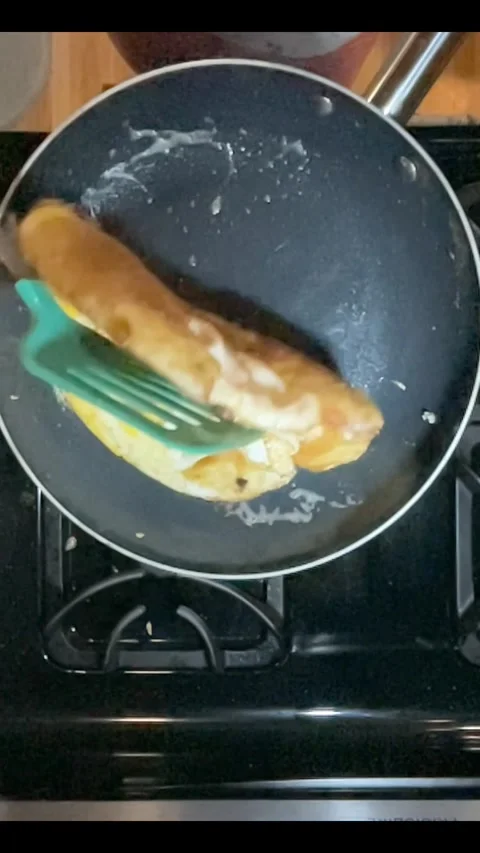 Flipping an ugly omelet Stock Footage 255455659