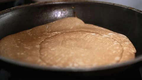 Flips blin in frying pan, cooking crepes at home, sweet french and russian Stock-Footage 229553192