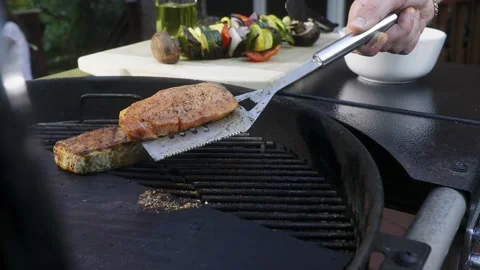 Flips the meat on the grill Stock Footage 223175525