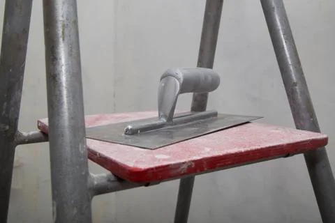 Float for applying putty at a ladder during a renovation Stock Photos