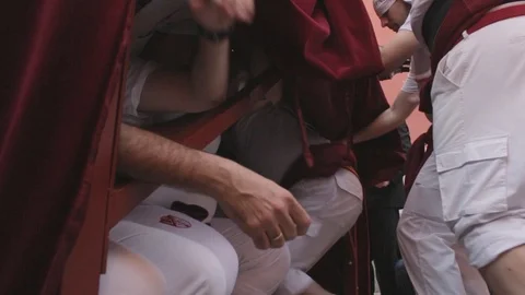 Float bearers resting under the pass while others go inside in the spanish Video stock 105677512