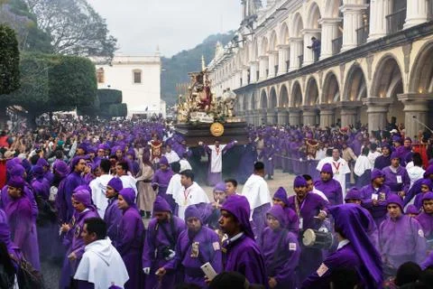 Float with Christ statue carried by purple robed men at the procession San Ba Stock Photos