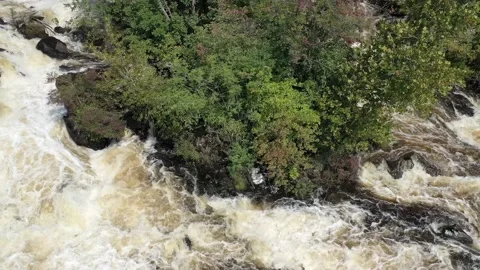 Float low over a raging river and rocks after a rain storm-aerial Stock Footage 161332357