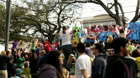 Float passes by as people cheer in mardi gras parade Stock Footage 10827560