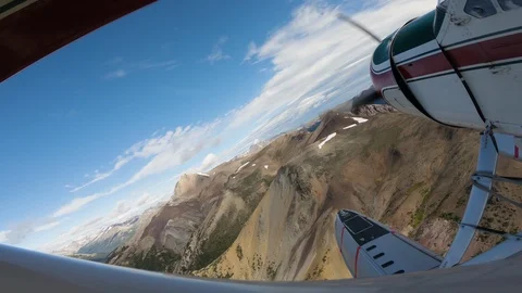 Float Plane Flying Low Over Rugged Mountains Video stock 115057363