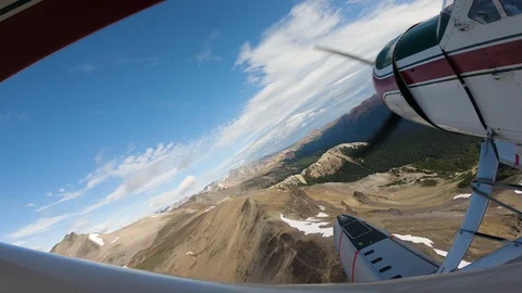 Float Plane Flying Lower Over Rugged Snow Capped Mountains 스톡 동영상 115056387