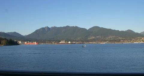 Float plane landing on water in front of stanley park Stock Footage 120649721