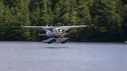 A Float Plane lands on a small lake in Northern Ontario. Stock Footage 91414122