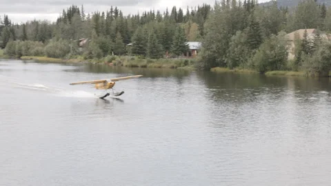 Float plane taking off from the chena river at fairbanks, alaska Stock Footage 336151393