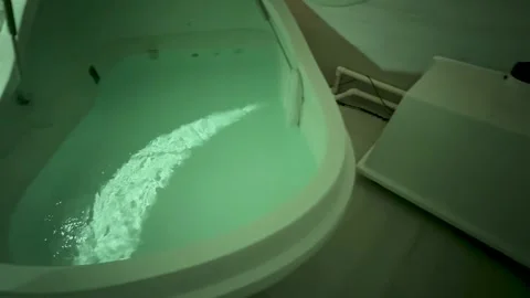 Float Tank Interior with Calm Water and Blue Foam Headrest Detail Stock Footage 310519495