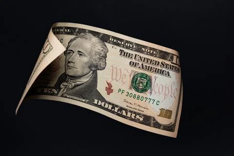 Floating 10 US Dollar Bill with Alexander Hamilton on Black Background Stock Photos
