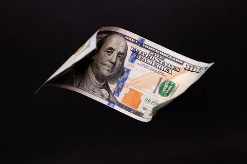 Floating 100 US Dollar Bill over Solid Black Background Stock Photos