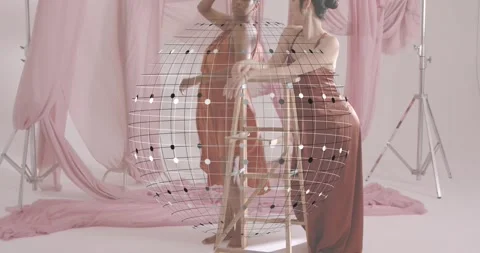With floating 3D sphere centering pink fashion shoot two female models posing Stock Footage 319784171