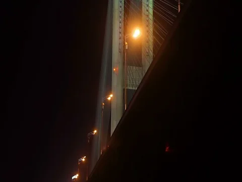 Floating along  illuminated bridge at night Stock Footage 71862289