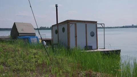 Floating Bathhouse Sauna and Large Tent Standing on Lake Pier Stock-Footage 342766091