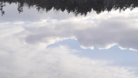 Floating beautiful clouds reflected in calm water Stock Footage 74065659