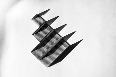 Floating black rectangular shapes made of staples in a diagonal arrangement Stock Photos