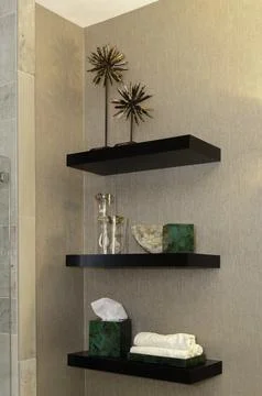 Floating Black Shelves With Decorative Items And Toiletries In Bathroom. Stock Photos