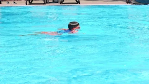 Floating boy on blue swimming pool in resort. Summer vacation, tourism concept Stock Footage 169959886