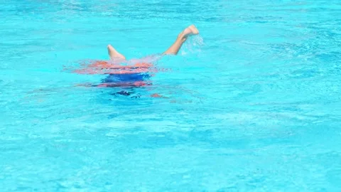Floating boy on blue swimming pool in resort. Summer vacation, tourism concept Stock Footage 169960369