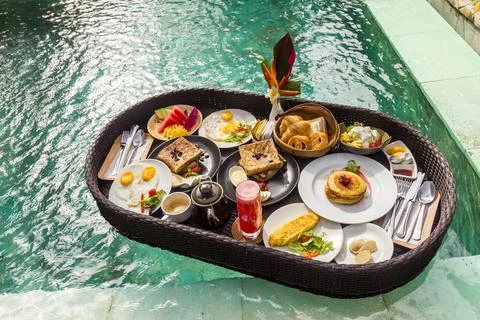 Floating breakfast in a swimming pool Stock Photos