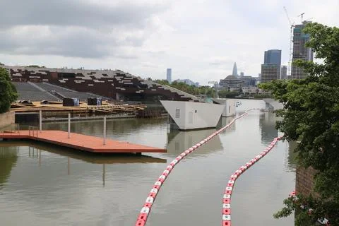 A floating bridge is being constructed across the river in front of the hig.. Stock Photos