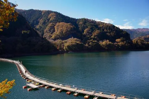 Floating bridge of drum containers on lake in Japan, sunny autumn day Stock Photos