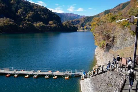Floating bridge of drum containers on lake in Japan, sunny autumn day Stock Photos