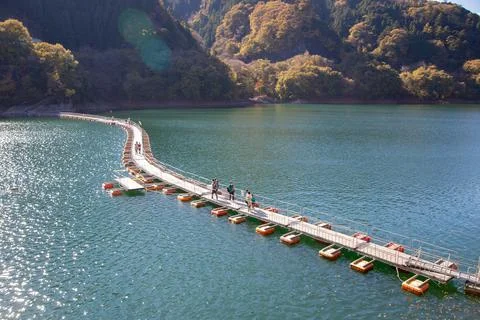 Floating bridge of drum containers on lake in Japan, sunny autumn day Stock Photos