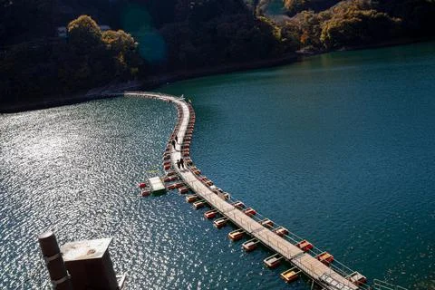Floating bridge of drum containers on lake in Japan, sunny autumn day Stock Photos