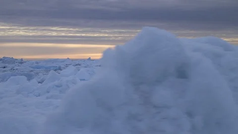 Floating broken iceberg and brash, Greenland, Arctic Ocean, sunset cloudy sky Video stock 92111616