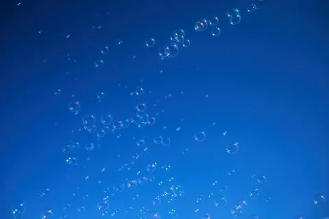 Floating Bubbles Against Blue Sky Foto stock