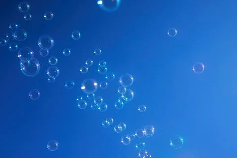 Floating Bubbles Against Blue Sky Stock Photos