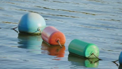 Floating buoys on the water Stock Footage 325979009