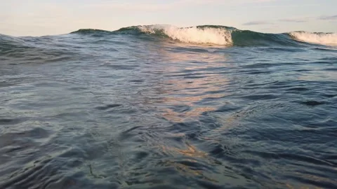Floating in Calm Ocean Waves at Sunset 스톡 동영상 331153462