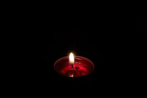 Floating candle burns in the dark, fire and light Stock Photos